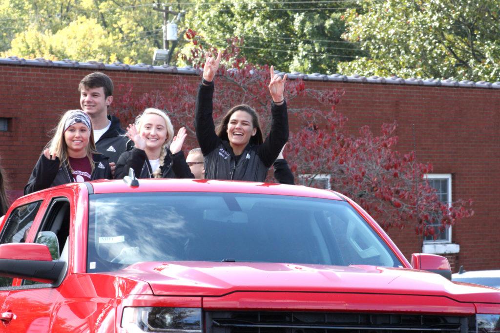 From left, Kayla Miracle, Taylor Blevins, Randal Parmley and Jessica Howard, CU cheerleaders, ride on a float during the 2017 Homecoming Parade at downtown Campbellsville. (Campbellsville University Photo by Andrea Burnside)